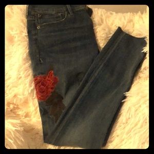 Express skinny jeans embroidered with rose .